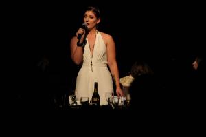 Nicole Zucarello speaks under a spotlight