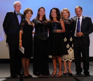 Leaders of Rocky Mountain Crisis Partners accept the Organization of the Year award from the Tribute co-chairs. 