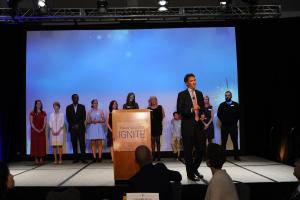 Andrew Romanoff invites the staff of Mental Health Colorado on stage during his call to action